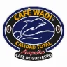 Logotipo de Café Wadi: delfín azul sobre un grano de café, con las leyendas Calidad Total, Acapulco y Café de Guerrero